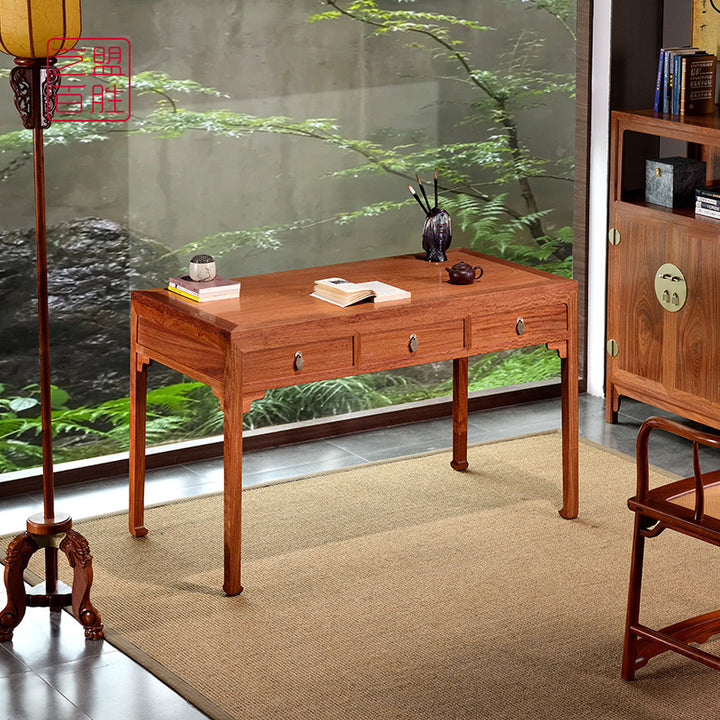 Three-drawer desk made of Pterocarpus macrocarpus wood.