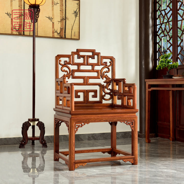 A Pterocarpus macrocarpus armchair with intricate Fu and Shou carvings.