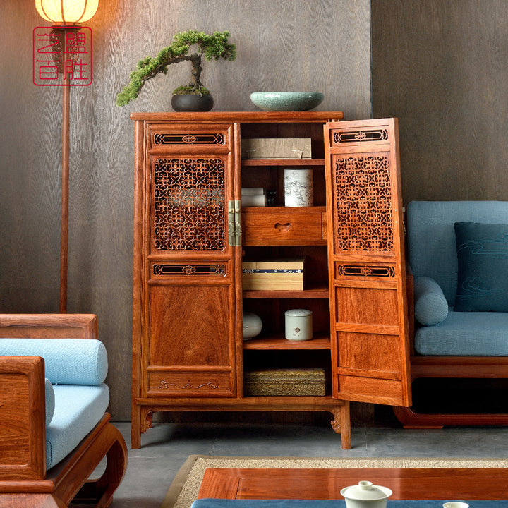 Traditional Chinese Pterocarpus macrocarpus cabinet with hollow carved designs.