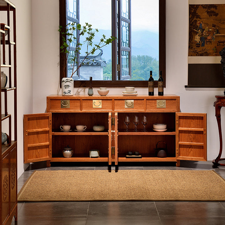 Stylish four-drawer sideboard in Pterocarpus macrocarpus with brass accents.