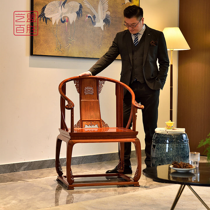 Classic Pterocarpus armchairs and tea table with detailed scroll designs