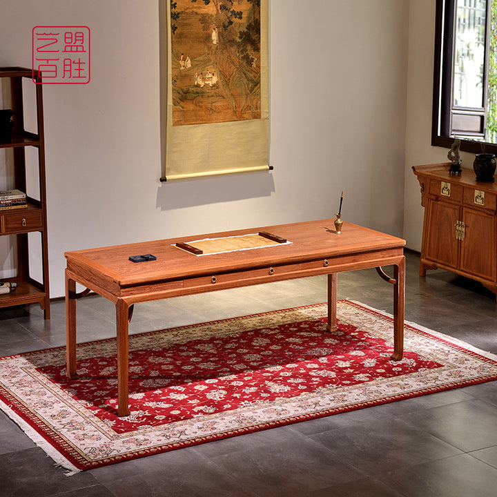 Elegant Pterocarpus Macrocarpus six-drawer desk on a red patterned rug