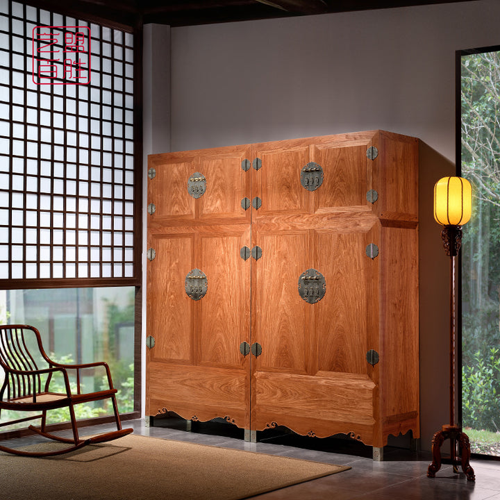 A large wooden cabinet made from Pterocarpus macrocarpus with a rolling cloud top design.