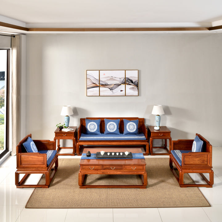 A plain rosewood sofa set with blue cushions in a modern living room.