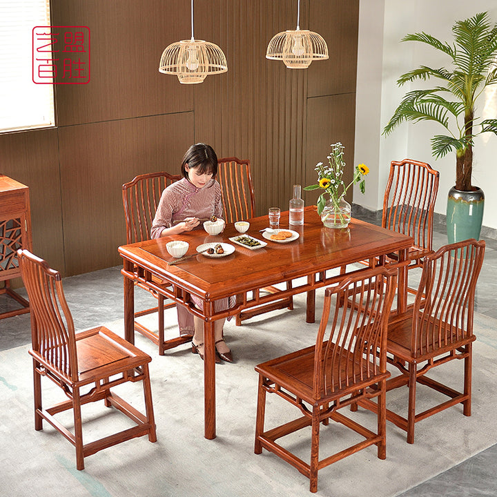 A Pterocarpus macrocarpus dining table set with six lantern-style chairs