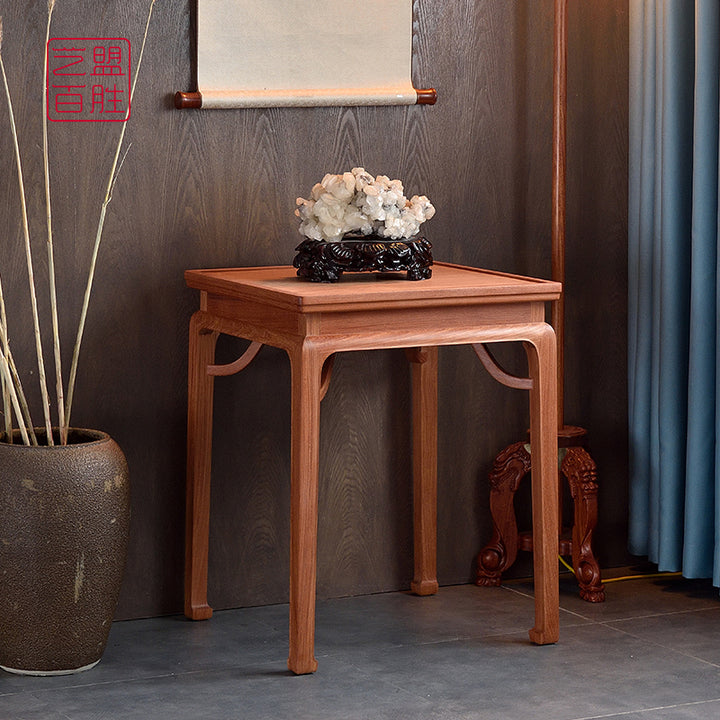 A Pterocarpus macrocarpus side table with elegant curved legs