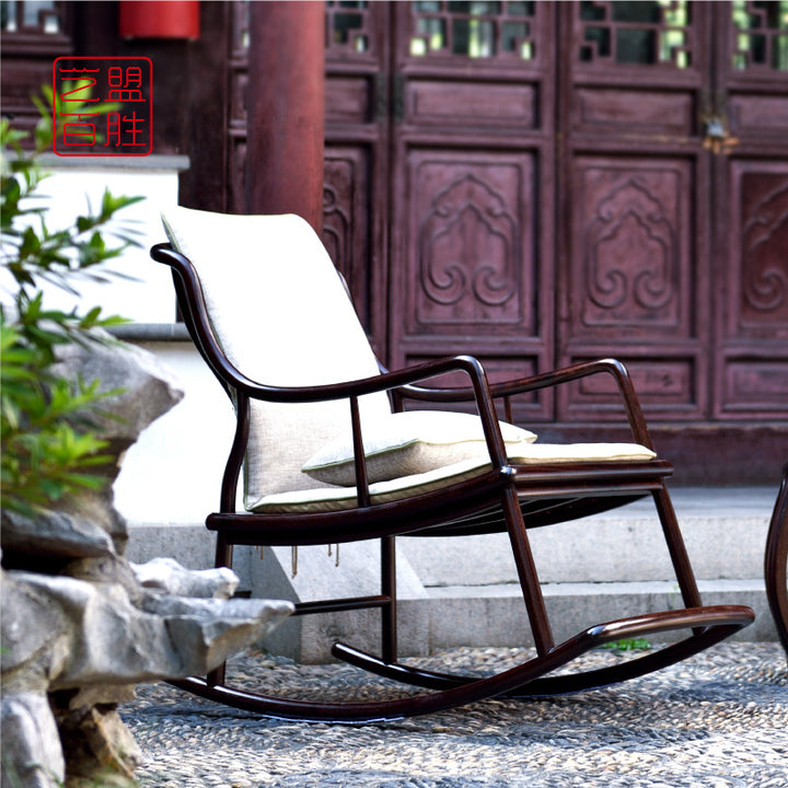 Beautifully crafted rosewood rocking chair on a stone walkway