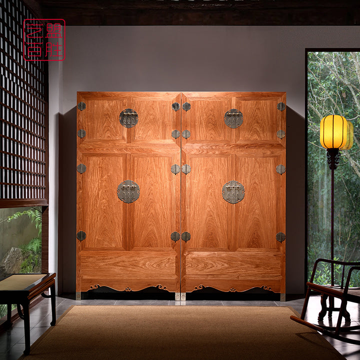 Pterocarpus macrocarpus cabinet with decorative metal hinges and a cloud pattern on the top.