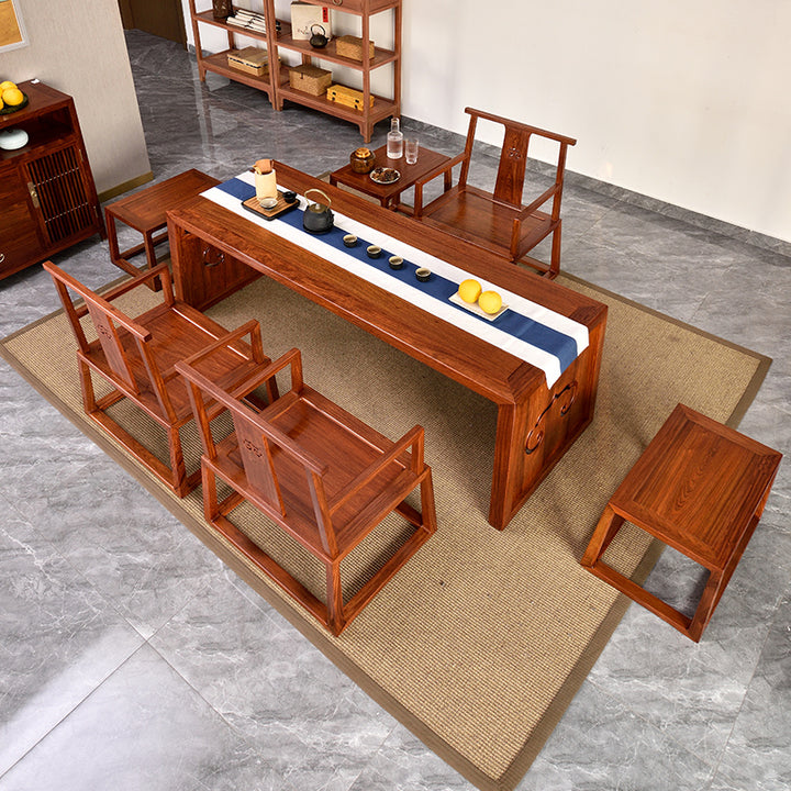 Handcrafted Pterocarpus tea table set featuring cloud motifs and wooden benches.