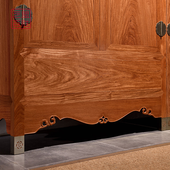 Sophisticated wooden cabinet with a natural finish and ornate rolling cloud top.