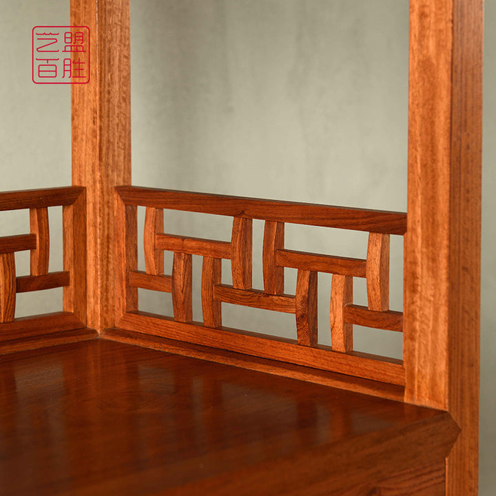 Carved wooden bookshelf with storage drawers and decorative items