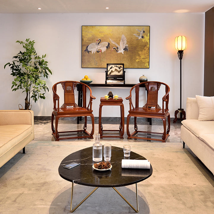 Pair of Pterocarpus macrocarpus semi-circular armchairs with scroll carvings and a small tea table