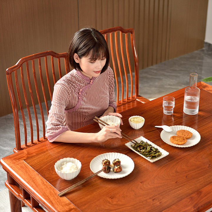 Traditional Chinese Pterocarpus macrocarpus dining table with matching chairs.