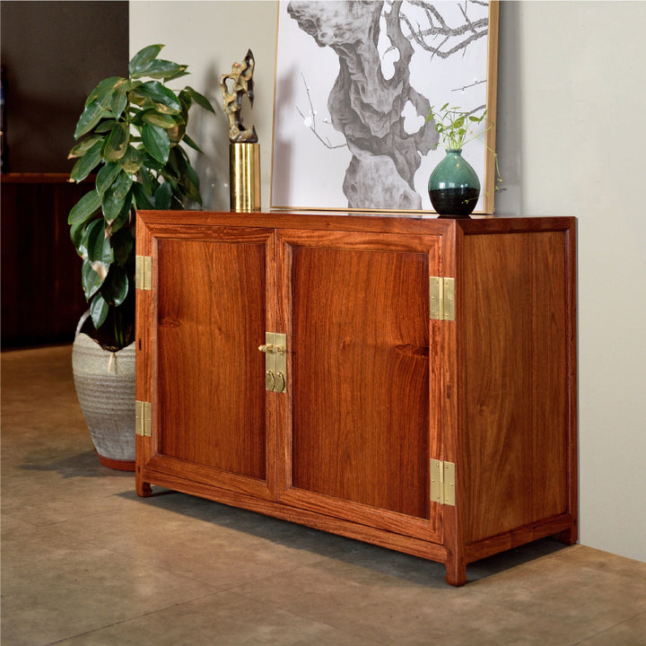 Classic Pterocarpus macrocarpus small cabinet with brass hinges and latch.