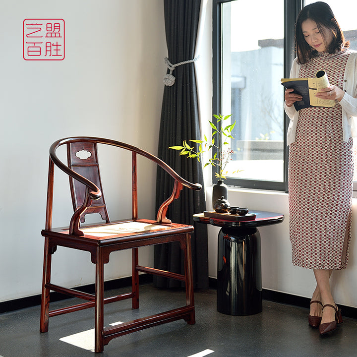 Handcrafted round-back armchair featuring cane seating