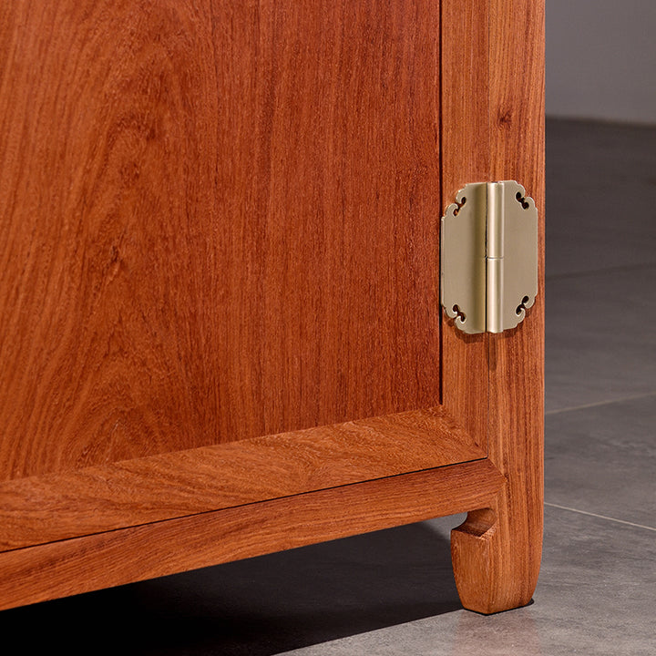 Four-drawer Pterocarpus macrocarpus sideboard with brass handles.