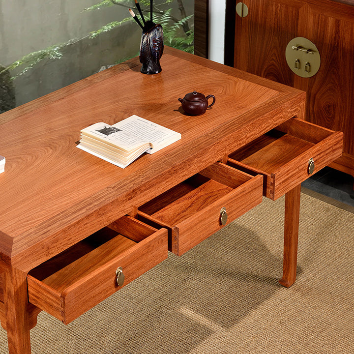 Classic Pterocarpus macrocarpus three-drawer desk.