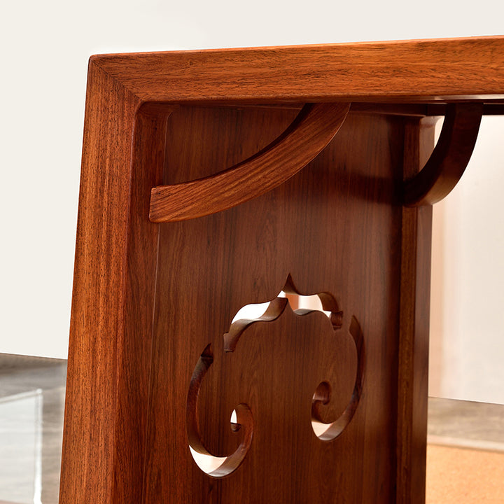 Beautiful Pterocarpus tea table set with matching chairs and benches in a serene setting.