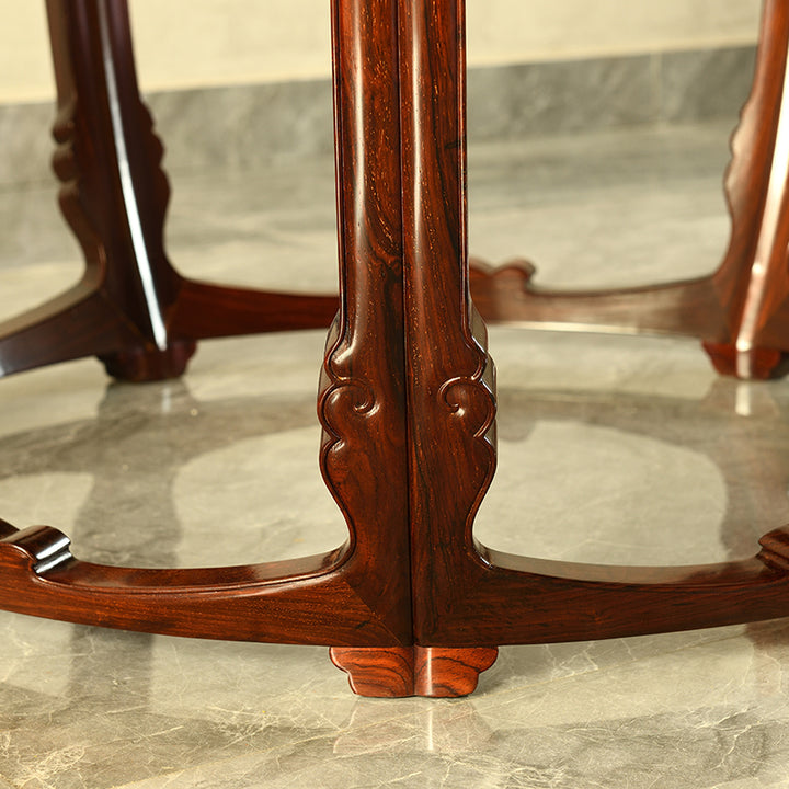 Artistic view of a rosewood round table with five beautifully carved legs and a unique concave top