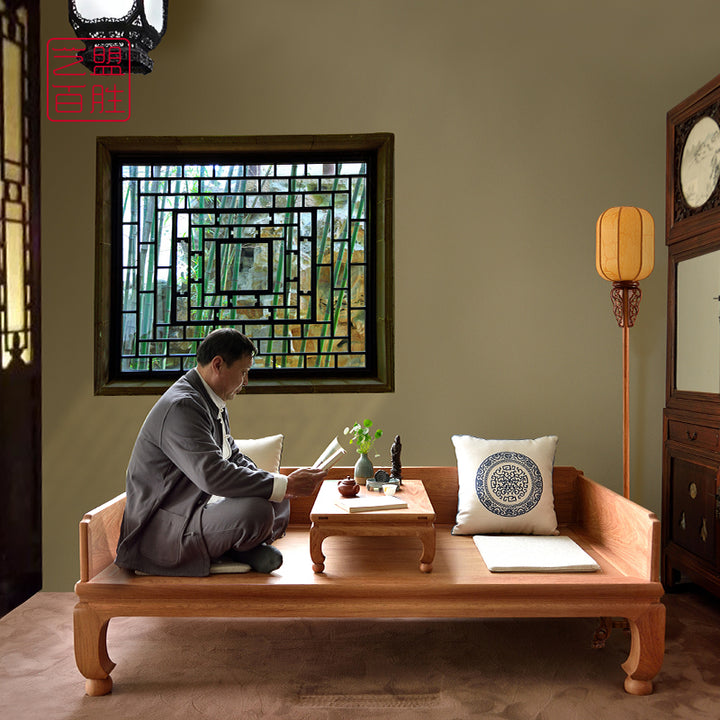 Luxurious Pterocarpus macrocarpus daybed with round ball feet and a matching wooden tea table.