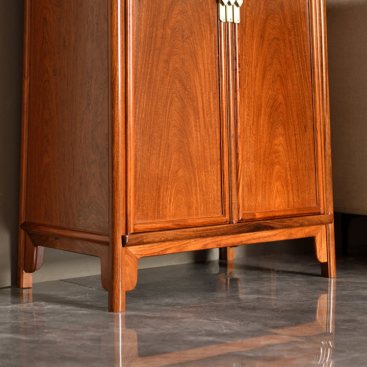 A large rosewood cabinet with rounded corners and two doors.