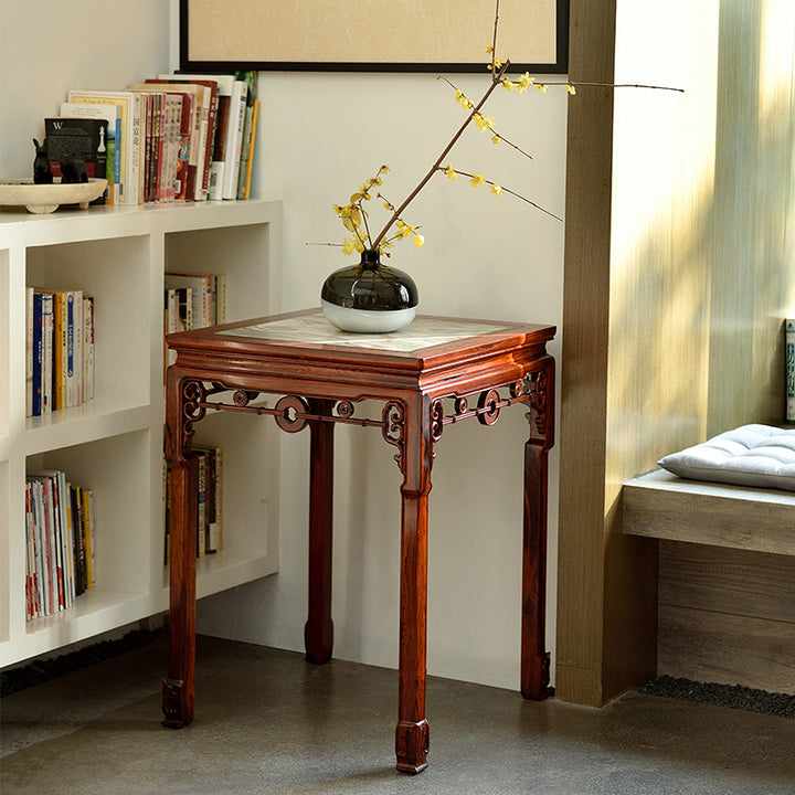 Luxury rosewood table with concave edges and a smooth, polished marble inlay