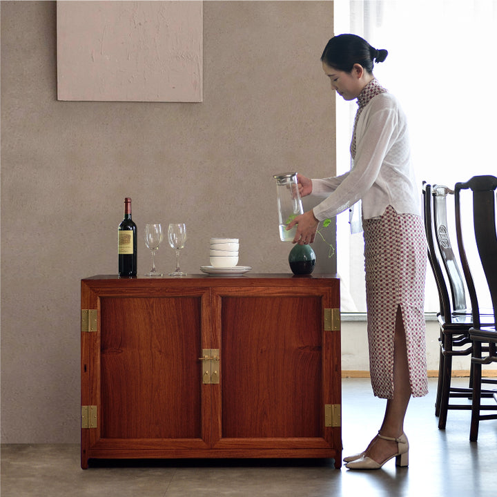 A small square corner cabinet made of Pterocarpus macrocarpus.