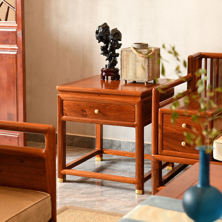 Beautifully crafted Pterocarpus macrocarpus sofa set with blue accent pillows.