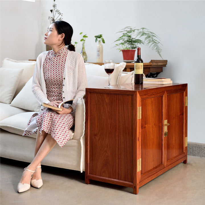 Elegant Pterocarpus macrocarpus small square corner cabinet with brass hardware.